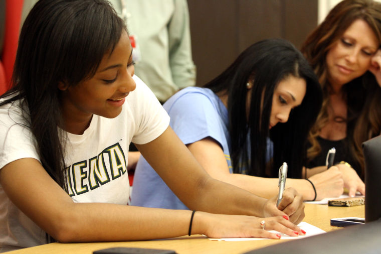 Heights volleyball duo sign with DI schools